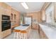 Traditional kitchen with light wood cabinets, central island and white countertops and appliances at 600 Driftwood Dr, Gibsonville, NC 27249