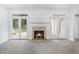 Bright living room featuring a fireplace, carpet, and glass doors to backyard at 600 Driftwood Dr, Gibsonville, NC 27249