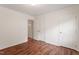 Well-lit bedroom showing wood floors, closet space, and easy access to additional rooms at 6540 English Oaks Dr, Raleigh, NC 27615