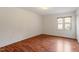Bright bedroom featuring wood floors and a large window for natural light at 6540 English Oaks Dr, Raleigh, NC 27615