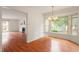 Elegant dining area with bay window and chandelier, connected to the living room with fireplace at 6540 English Oaks Dr, Raleigh, NC 27615