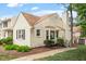 Charming townhome with light yellow siding, brown roof, and landscaped front yard at 6540 English Oaks Dr, Raleigh, NC 27615