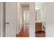 Hallway view showcases access to bathroom, additional rooms, and storage closets at 6540 English Oaks Dr, Raleigh, NC 27615