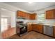 Functional kitchen with stainless steel appliances and natural wood cabinets at 6540 English Oaks Dr, Raleigh, NC 27615