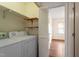 Functional laundry room equipped with appliances and shelving with access to another room at 6540 English Oaks Dr, Raleigh, NC 27615