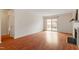 Open living room featuring wood floors, a fireplace, and sliding glass doors to the deck at 6540 English Oaks Dr, Raleigh, NC 27615