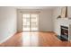 Bright living room with wood floors, fireplace, and sliding door access to the outdoor space at 6540 English Oaks Dr, Raleigh, NC 27615