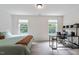 Well-lit bedroom featuring neutral colors, a comfortable bed, and a convenient desk area at 68 Tanners Way, Clayton, NC 27527