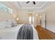 Comfortable bedroom features tray ceilings and hardwood floors, creating a relaxing ambiance at 68 Tanners Way, Clayton, NC 27527