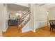 Bright foyer showcasing hardwood floors, elegant staircase, and inviting open layout to the living spaces at 68 Tanners Way, Clayton, NC 27527