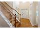 Spacious foyer with hardwood floors, staircase, and ample natural light creates a welcoming entrance at 68 Tanners Way, Clayton, NC 27527