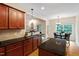Charming eat-in kitchen with island, granite counters, stainless steel appliances and backyard view at 68 Tanners Way, Clayton, NC 27527