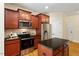 Bright eat-in kitchen with stainless steel appliances, island, granite countertops and ample cabinet space at 68 Tanners Way, Clayton, NC 27527
