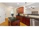 Open kitchen with granite countertops, stainless steel appliances, island and view into the living room at 68 Tanners Way, Clayton, NC 27527