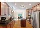 Spacious kitchen with stainless steel appliances, granite counters, island and an eat-in dining area at 68 Tanners Way, Clayton, NC 27527