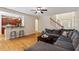 Open living room with a view into the kitchen with a breakfast bar and wood floors throughout at 68 Tanners Way, Clayton, NC 27527