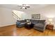 Inviting living room with hardwood floors, a sectional sofa, and plenty of natural light, perfect for relaxation at 68 Tanners Way, Clayton, NC 27527