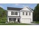 Charming two-story home with classic design, black shutters and a manicured lawn in a desirable neighborhood at 705 Comice Pear Way, Willow Springs, NC 27592