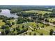 Beautiful aerial view of lakefront properties surrounded by dense forest and open land, showing the natural beauty of the area at 724 Harolds Northfield Dr, Cedar Grove, NC 27231