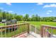 View of large backyard, as seen from a wood deck, featuring trampoline and partial view of Springdale trailer at 724 Harolds Northfield Dr, Cedar Grove, NC 27231