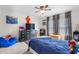 Bedroom with a ceiling fan, a bed with blue covers, and a dresser with toys and cartoon decor at 724 Harolds Northfield Dr, Cedar Grove, NC 27231
