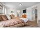 Comfortable main bedroom with wood floors and natural light with view into the ensuite bath at 724 Harolds Northfield Dr, Cedar Grove, NC 27231