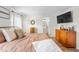 Comfortable main bedroom with wood floors and natural light with view into the ensuite bath at 724 Harolds Northfield Dr, Cedar Grove, NC 27231