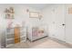 Cozy Bedroom with a white crib, cube storage shelves, a pink rug, and neutral decorations to create a warm, inviting atmosphere at 724 Harolds Northfield Dr, Cedar Grove, NC 27231