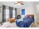 Bedroom with a ceiling fan, a bed with blue covers, and a dresser with toys and cartoon decor at 724 Harolds Northfield Dr, Cedar Grove, NC 27231