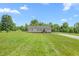 Well-manicured front lawn and landscape featuring a gravel driveway and tidy front walkway to home at 724 Harolds Northfield Dr, Cedar Grove, NC 27231