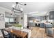 A modern kitchen with grey cabinets and stainless steel appliances with dining area and living room view at 724 Harolds Northfield Dr, Cedar Grove, NC 27231