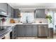 Bright kitchen featuring gray cabinetry, stainless steel appliances, and a view to the outdoors at 724 Harolds Northfield Dr, Cedar Grove, NC 27231