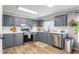 Updated kitchen with gray cabinets, white countertops, stainless steel appliances, and modern fixtures at 724 Harolds Northfield Dr, Cedar Grove, NC 27231
