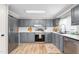 Modern kitchen with stainless steel appliances, gray cabinets and plenty of counter space for cooking at 724 Harolds Northfield Dr, Cedar Grove, NC 27231