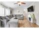 Comfortable living room featuring a plush gray sectional and a stylish electric fireplace feature at 724 Harolds Northfield Dr, Cedar Grove, NC 27231
