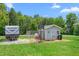 RV and shed with a basketball hoop and fenced in dog run in a backyard setting at 724 Harolds Northfield Dr, Cedar Grove, NC 27231