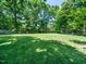 Expansive backyard features lush lawn and mature trees, providing ample space for recreation and relaxation at 7605 Copper Mine Ln, Raleigh, NC 27615