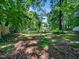 A large, treed backyard provides a private and natural setting with mature trees at 7605 Copper Mine Ln, Raleigh, NC 27615