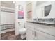 Updated bathroom with granite countertop vanity and shower with striped curtain at 7605 Copper Mine Ln, Raleigh, NC 27615