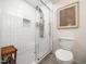 Updated bathroom with glass-enclosed shower, sleek fixtures, and modern tile flooring at 7605 Copper Mine Ln, Raleigh, NC 27615