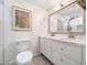 Bright bathroom featuring a dual vanity, framed mirror, and tiled floors, offering a clean aesthetic at 7605 Copper Mine Ln, Raleigh, NC 27615