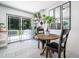 Bright dining area with a view of the deck, modern tile flooring, and seating for two at 7605 Copper Mine Ln, Raleigh, NC 27615