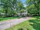 Traditional two-story home with a long driveway, mature trees, and a spacious front yard at 7605 Copper Mine Ln, Raleigh, NC 27615