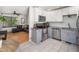 Modern kitchen with stainless steel appliances, white upper cabinets, and gray lower cabinets at 7605 Copper Mine Ln, Raleigh, NC 27615
