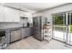 Modern kitchen with stainless steel appliances, granite countertops, and stylish two-tone cabinetry at 7605 Copper Mine Ln, Raleigh, NC 27615