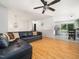 Open-concept living room featuring hardwood floors, modern lighting, and sliding glass doors at 7605 Copper Mine Ln, Raleigh, NC 27615