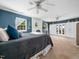 Spacious main bedroom featuring a brick fireplace, blue accent wall, and ample closet space at 7605 Copper Mine Ln, Raleigh, NC 27615