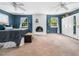 Spacious main bedroom with blue walls, white brick fireplace, and large windows at 7605 Copper Mine Ln, Raleigh, NC 27615