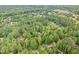 Aerial view showing a home surrounded by lush trees in a peaceful neighborhood setting at 7801 Wood Way Ct, Raleigh, NC 27606
