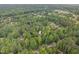 Aerial view of neighborhood, showing home nestled among lush trees in a peaceful neighborhood setting at 7801 Wood Way Ct, Raleigh, NC 27606